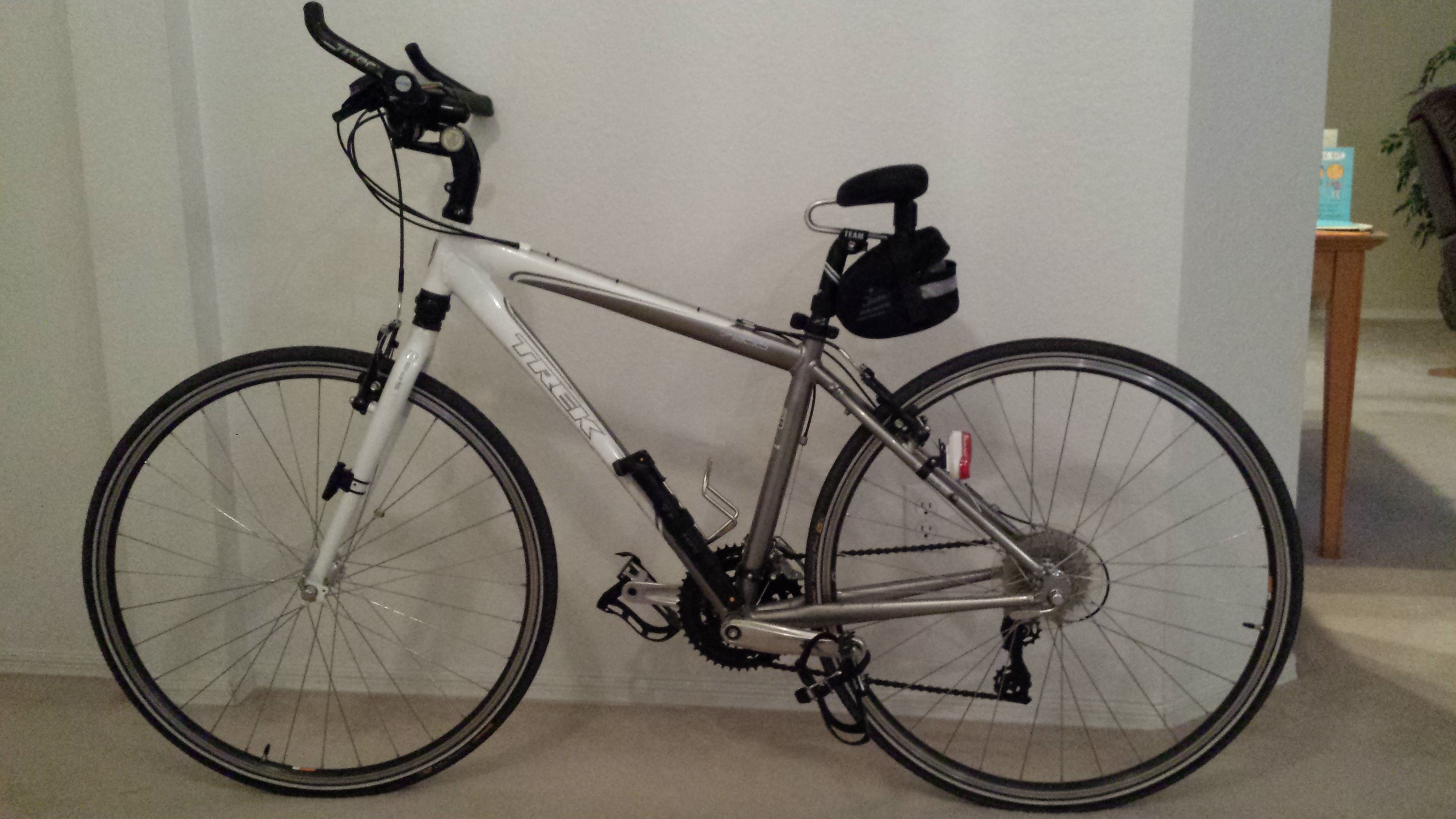 Kona Mountain bicycle leaning against a wall with horneless saddle